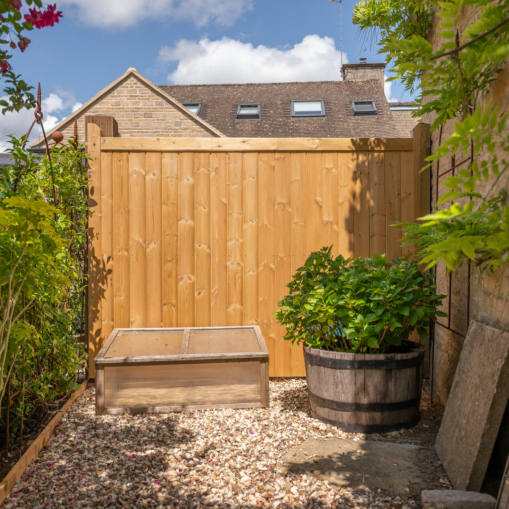 Lifestyle shot of Highampton Mortise & Tenon Fence Panel installed in garden