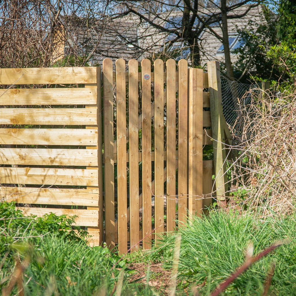 Pressure Treated Picket Side Gate with Round Top installed in garden setting, demonstrating how the height and traditional picket design provides an attractive and secure garden entrance