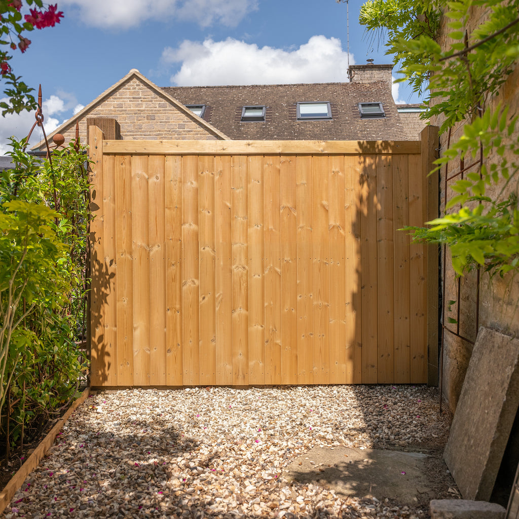 Lifestyle shot of Highampton Mortise & Tenon Fence Panel installed in garden