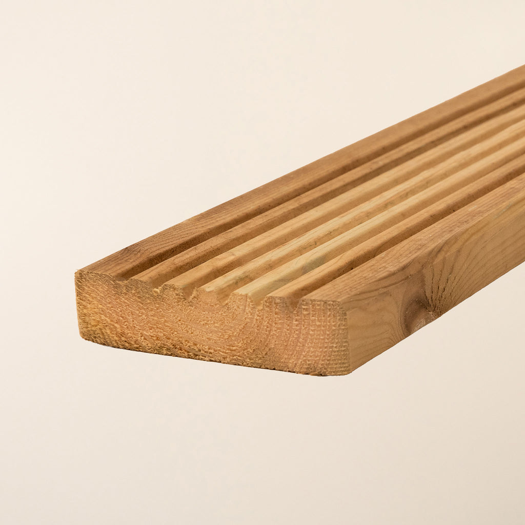 Close-up view of Premium Decking Boards showing the smooth surface texture and grain pattern of the kiln-dried softwood with green pressure treatment for outdoor durability 