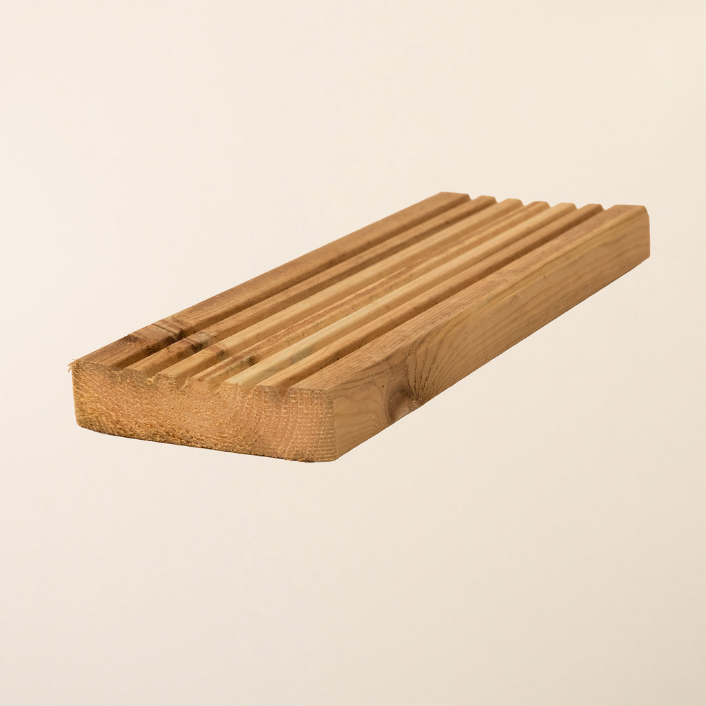 Close-up view of Premium Decking Boards showing the smooth surface texture and grain pattern of the kiln-dried softwood with green pressure treatment for outdoor durability