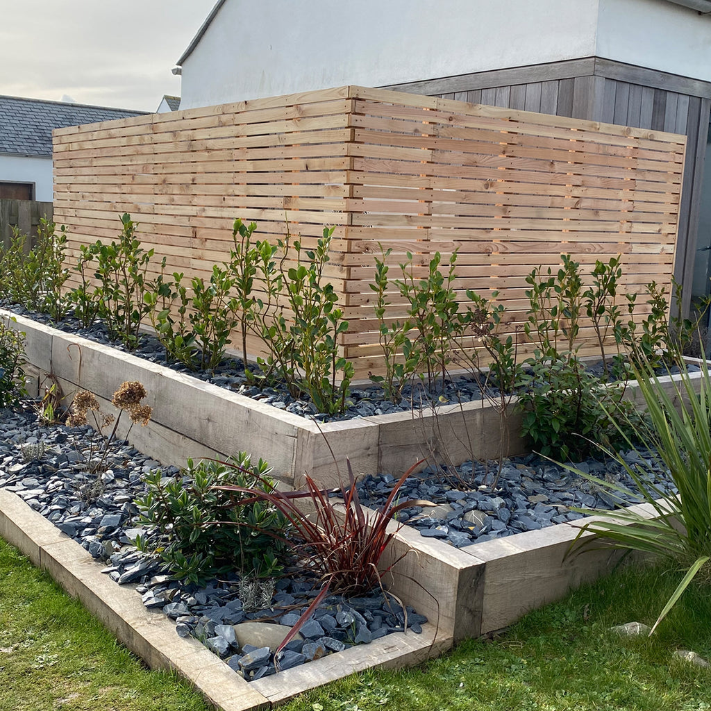 customer photo of timber slatted panels in their garden