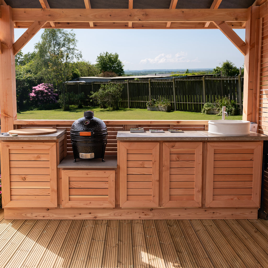 Wide shot showing entire kitchen unit in garden setting