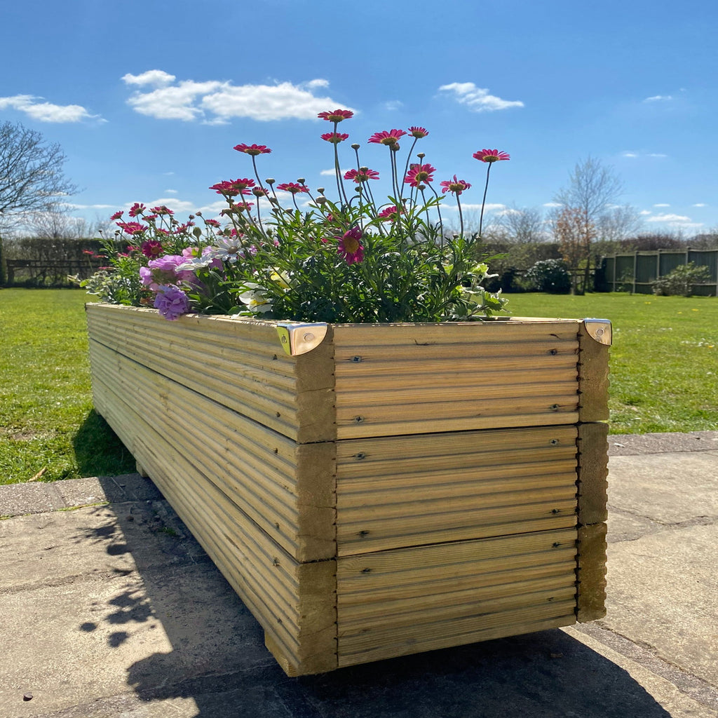 Deluxe Handmade timber Redwood Garden Planter with flowers in on a patio