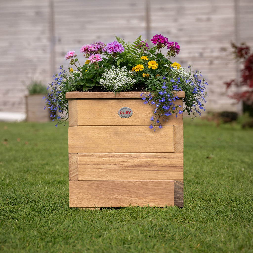 Premium Iroko Hardwood Overlap Planter in garden setting, showcasing how the natural hardwood complements plants and flowers while providing a stylish and durable container for outdoor growing 