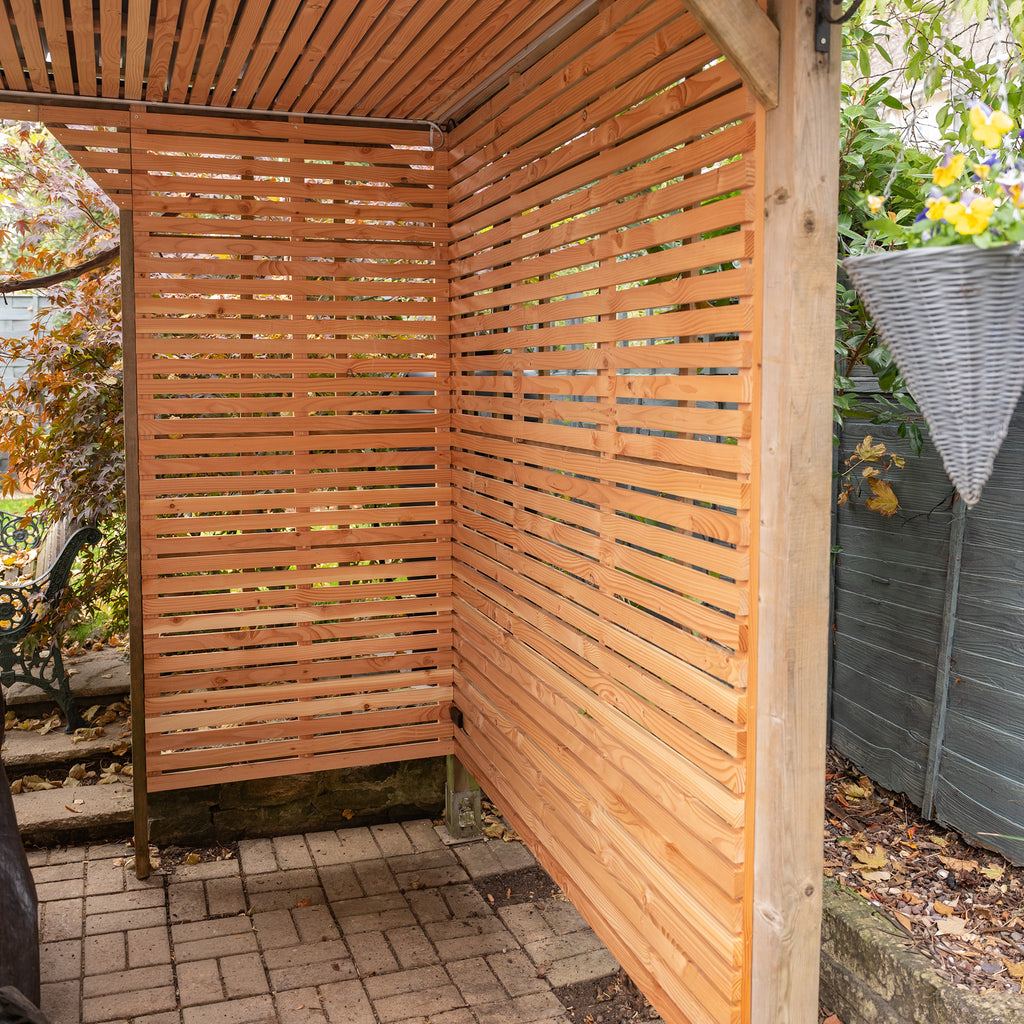 Lifestyle image of Larch Slatted Panels used in garden