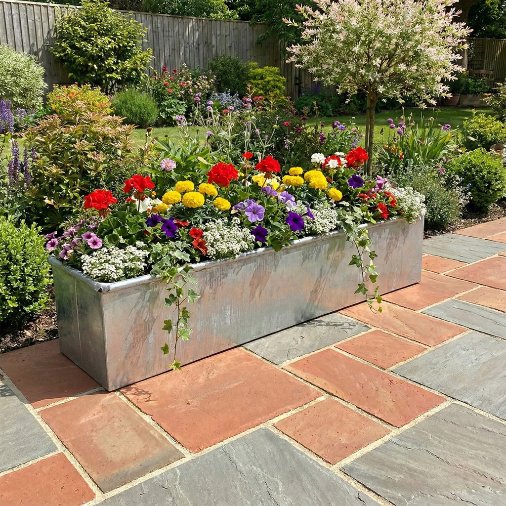 Lifestyle image of metal planter installed in a garden setting 