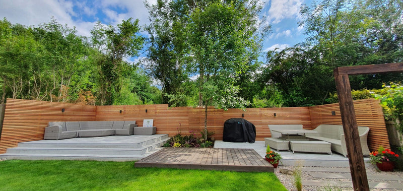 Contemporary Design Garden & Patio With Cedar Slatted Panels and a decking area