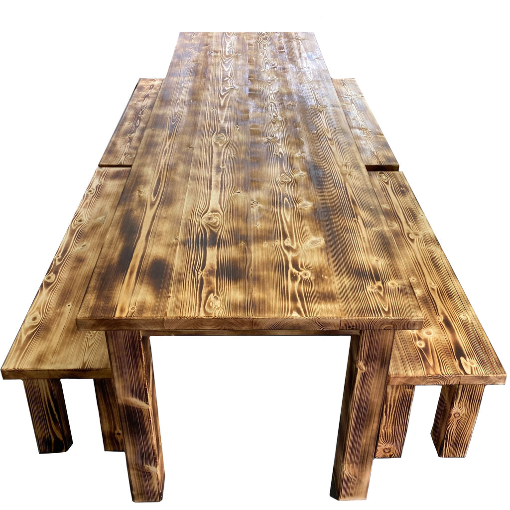 Stained wood indoor dining table with benches