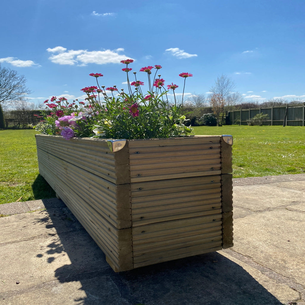 Deluxe Handmade timber Redwood Garden Planter with flowers in on a patio