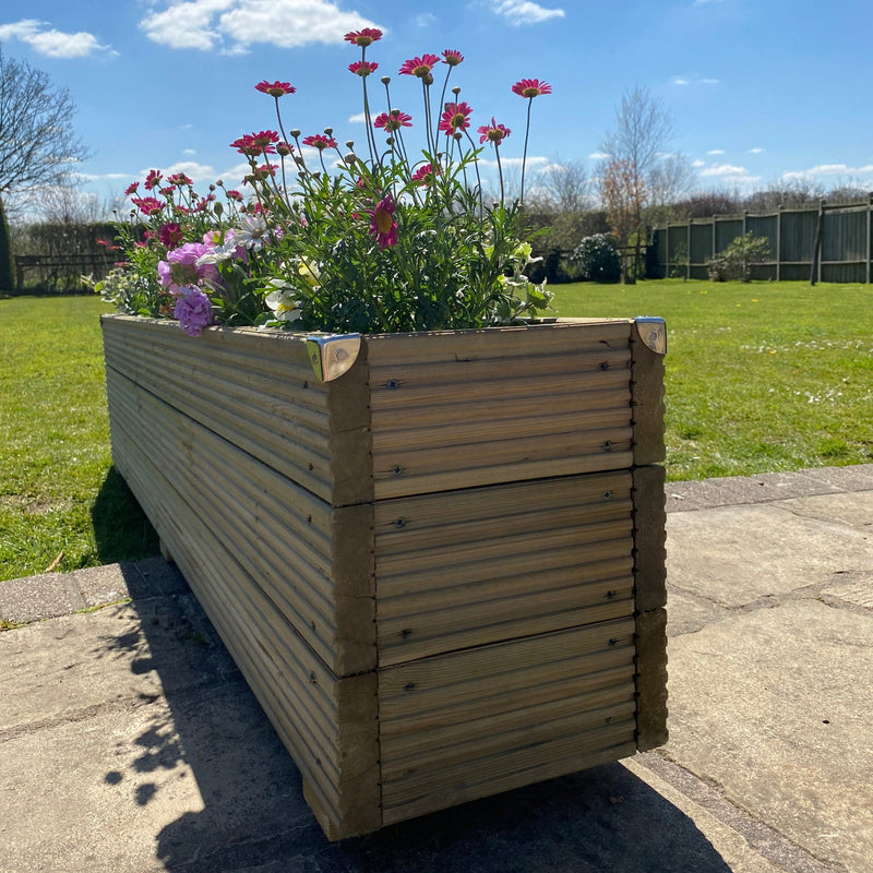 Deluxe Handmade timber Redwood Garden Planter with flowers in on a patio