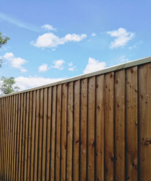 Rebated Fence Capping Rail shown on a featheredge fence