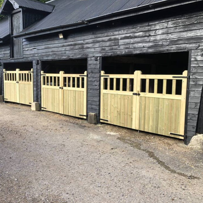 Pressure Treated Redwood timber Mortise & Tenon Driveway Gates attached to a barn