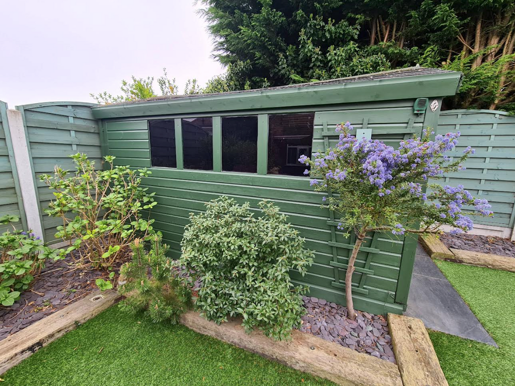 Shiplap redwood cladding timber garden room painted green