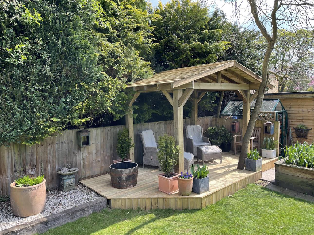 Timber pergola shown in a garden on decking