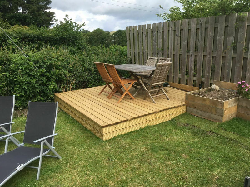 Cedar DIY Decking Kits in a garden with furniture on