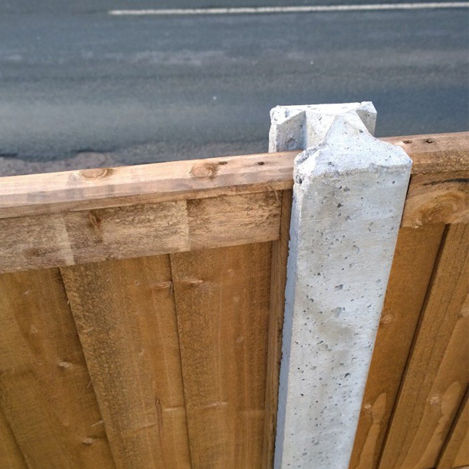 Close up of a concrete post with fence attached