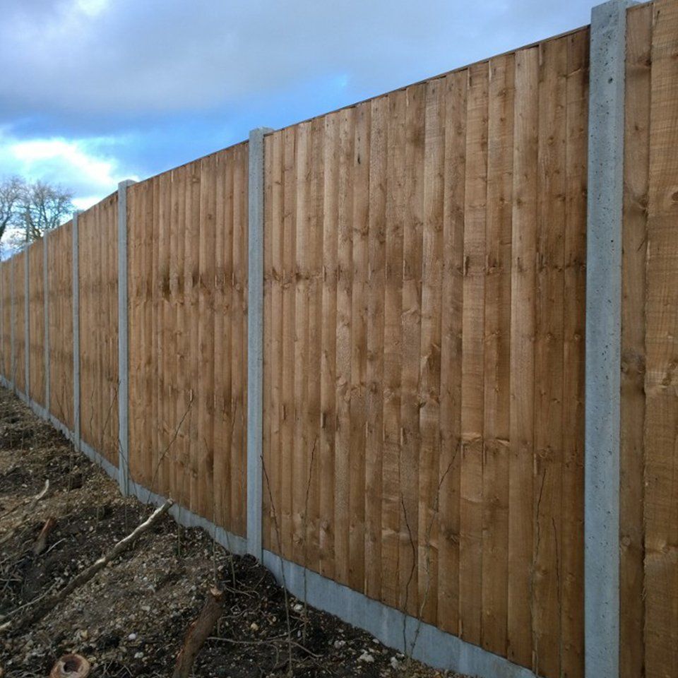 Concrete post with fence attached