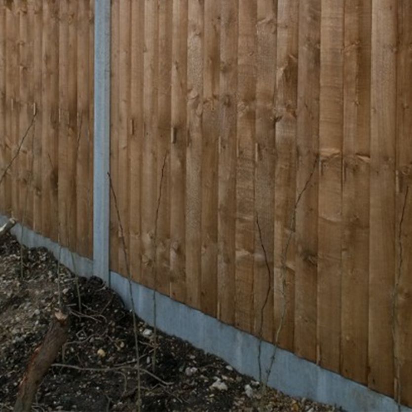 Concrete gravel board at fence base