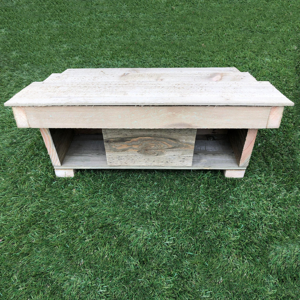 Handmade wooden Hedgehog House on grass